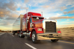 Red semi-trailer truck driving on a road | Driveline Services Australia