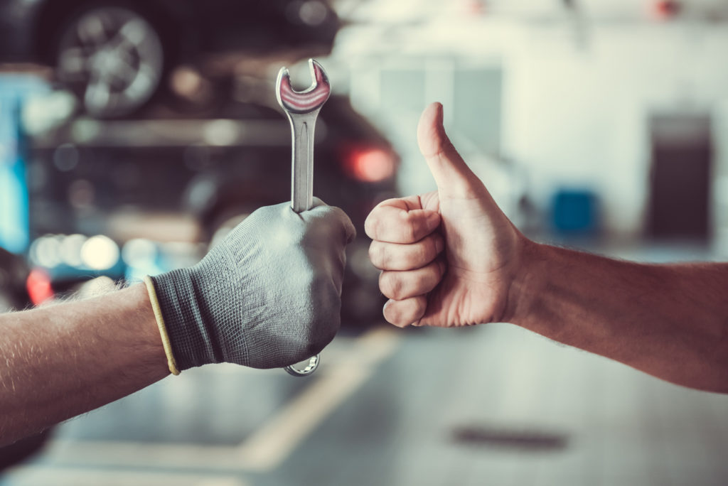 Man holding a wrench with another giving a thumbs up | Driveline Services Australia