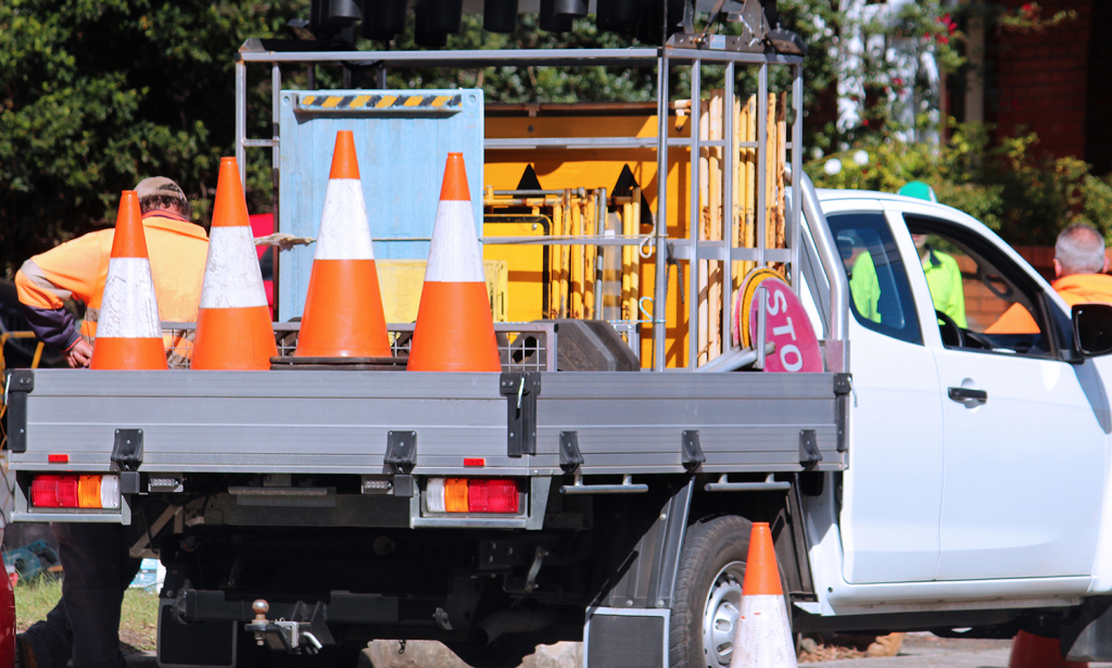 working ute with roadwork equipment in the tray