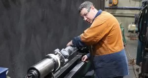 man repairing an underbody part